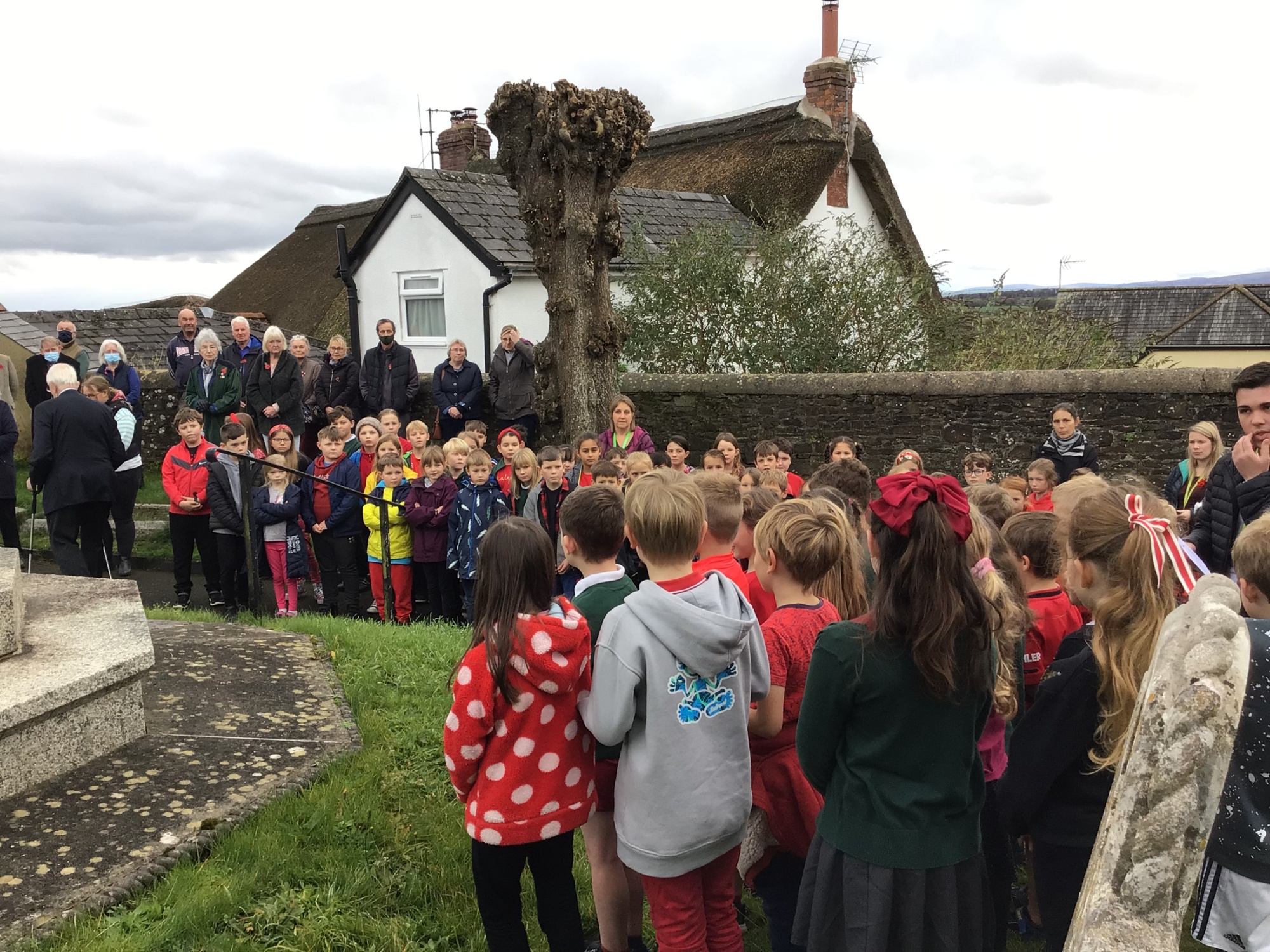 School children paying respects at war memorial on Remembrance Day
