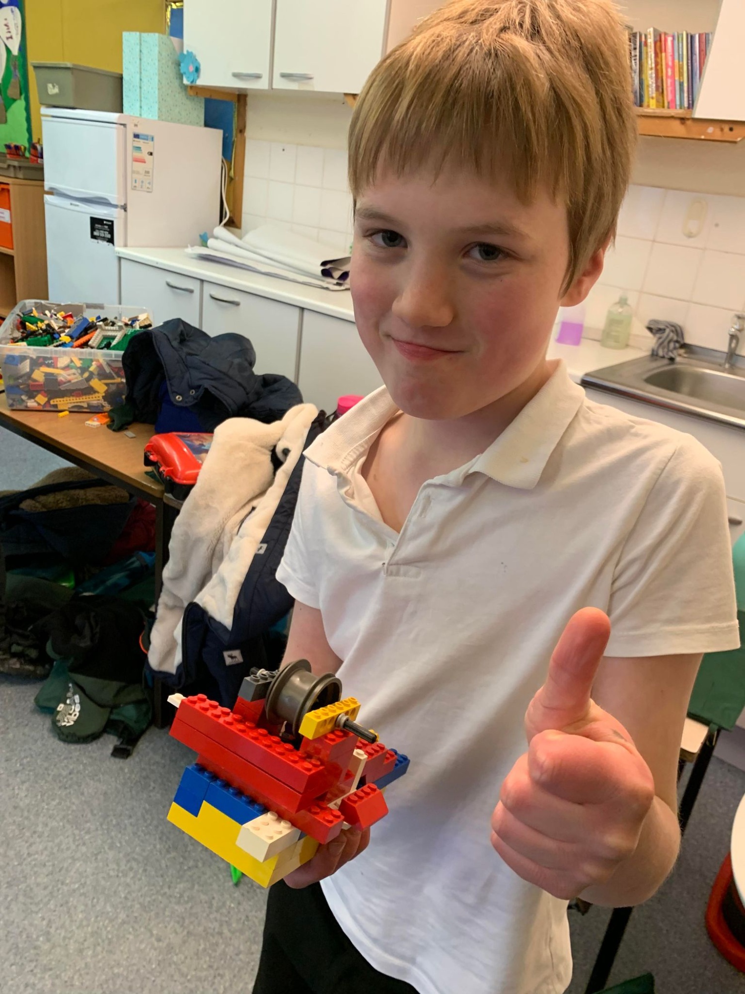 One child holding a Lego creation