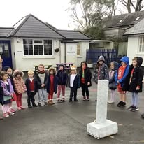 School children paying respects at war memorial on Remembrance Day
