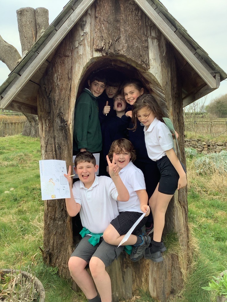 A row of children sat on surf boards on a beach